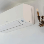 Camera Blu: Wall-mounted air conditioner unit with a decorative sconce. Interior design.