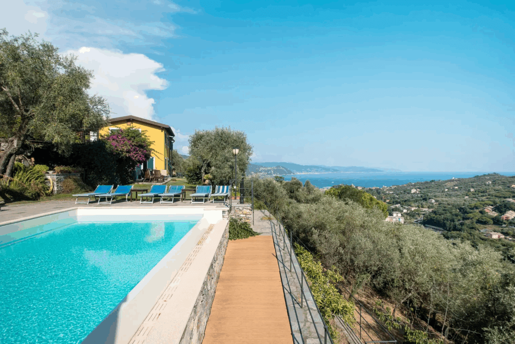 Casa di Pietra pool view. Swimming pool, sun loungers, and ocean view.