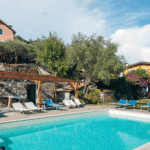 Casa di Pietra poolside view. Swimming pool with lounge chairs. Vacation rental.
